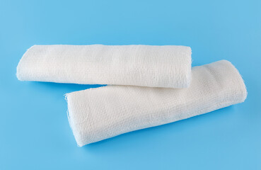 Gauze medical bandage on a blue background. Two rolls of bandage.