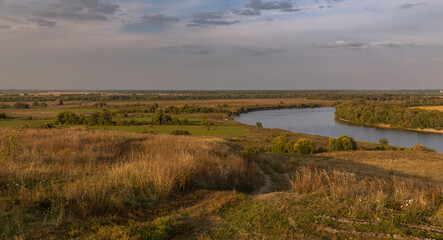 A large, open field with a river running through it
