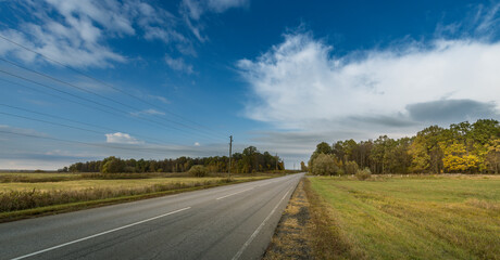 A road with a clear blue sky above it