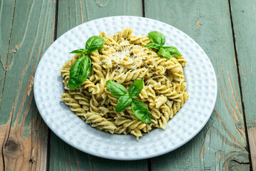Pasta with basil sauce pesto . Italian food photography . Top view