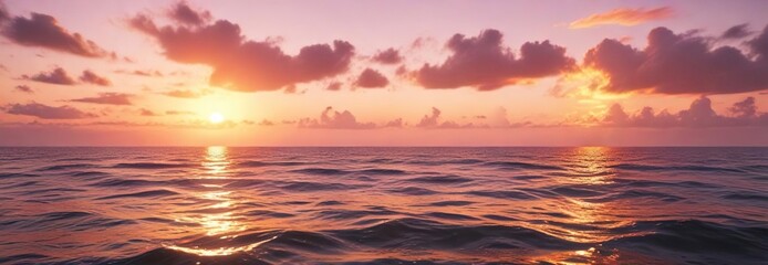 Fototapeta premium Soft pink and orange hues of sunset illuminate the calm ocean waters in a beautiful and peaceful scene, daybreak , serenity