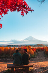 serene autumn view of mount fuji with a couple enjoying the scenery at lake kawaguchi, japan