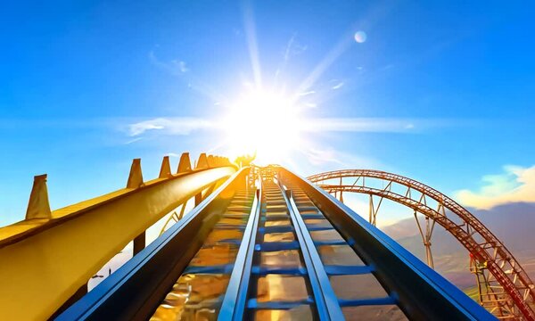 Roller coaster tracks leading to a bright sun in a blue sky.