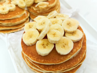 Plate of banana pancakes on table, closeup