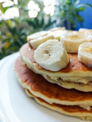Plate of banana pancakes on table, closeup