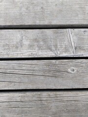 Gray background made of natural wooden boards with cracks