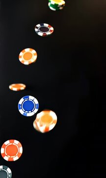 A row of poker chips are falling from the sky