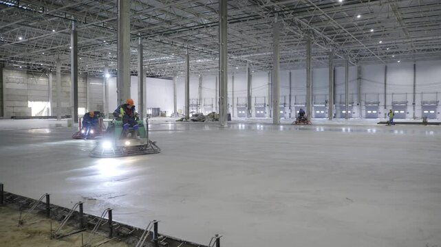 Concrete Flooring Installation in a Large, Open, and Spacious Warehouse Facility Environment. Clip