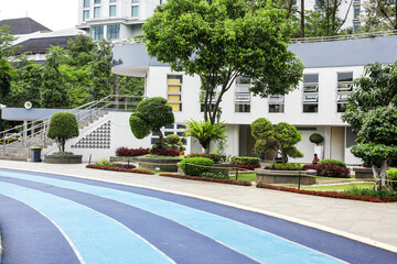 Running Track With Building And Variety of Plants
