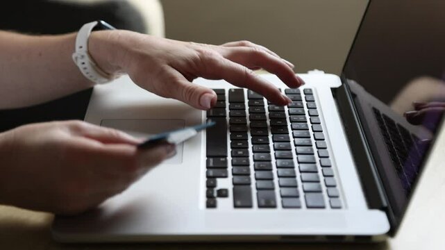 Woman paying with a card for online shopping on Cyber Monday, Black Friday