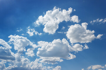 Sky was a tranquil electric blue, adorned with fluffy white cumulus clouds. This natural landscape was a serene canvas of calm and beauty in the atmosphere.