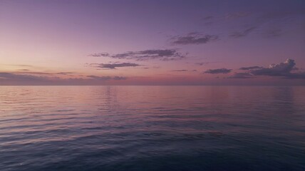 Fototapeta premium Serene Sunset Seascape: Tranquil ocean meeting a breathtaking purple and pink sunset. A picturesque view evoking peace and serenity. 