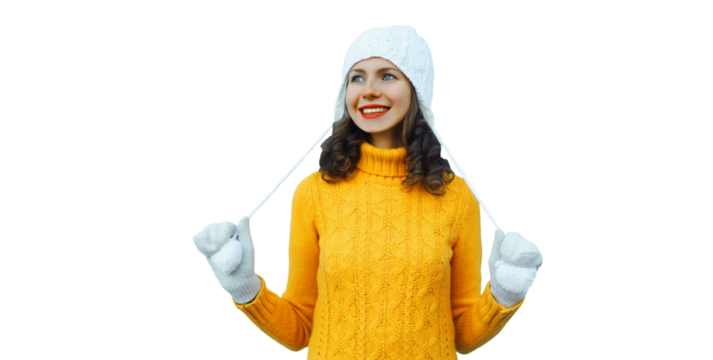 Winter christmas portrait of happy woman smiling in yellow sweater, white hat isolated on background