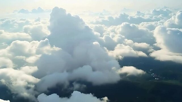 vue a&eacute;rienne au dessus des nuages qui se dissipe et laisse voir un paysage .