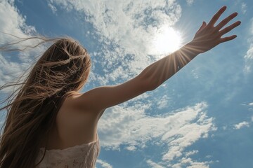 woman holding out her hand to the blue sky with clouds, hope and faith concept