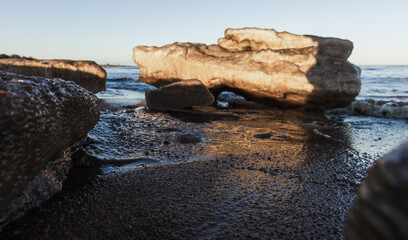 Dirty melting ice floes lay on the coast of Baltic Sea,