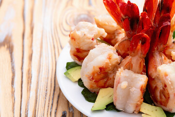 Salad with tiger shrimps , avocado and mango . Top view