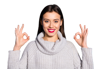 Portrait of charming millennial showing promo smiling at camera wearing gray jumper isolated over blue background