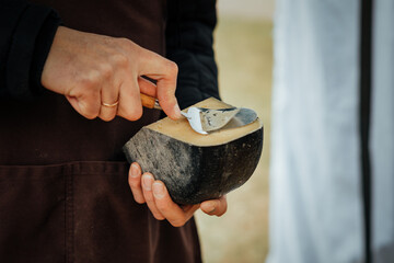 Artisan Cheese Being Sliced by Hand for Sampling