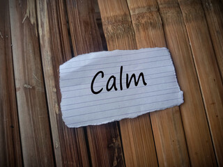 word CALM text on paper with bamboo background