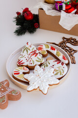  Cozy Christmas Photo with Hand-Painted Gingerbread Cookies on a Plate, Surrounded by Christmas Decor on a White Background
