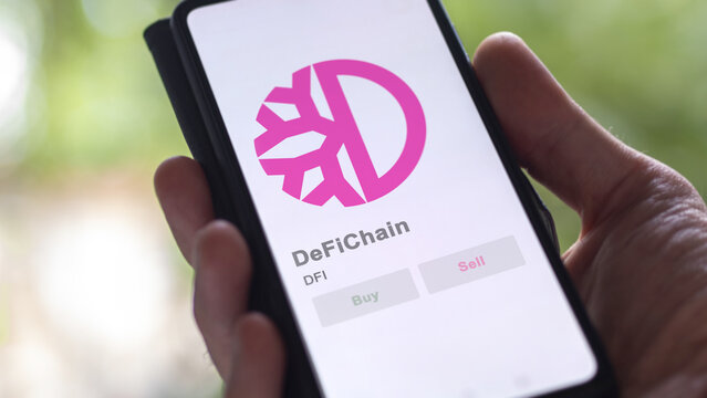 Close up on logo of (DFI) DeFiChain crypto asset on the screen of an exchange. (DFI) DeFiChain price stocks, $DFI on a device.