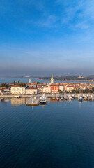 Fototapeta premium A stunning aerial view of Poreč, Croatia, featuring its charming waterfront, historic architecture, and a peaceful marina. 