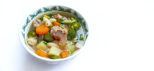Sayur sop or vegetable with meat soup on the plate. indonesian popular culinary. Healthy food