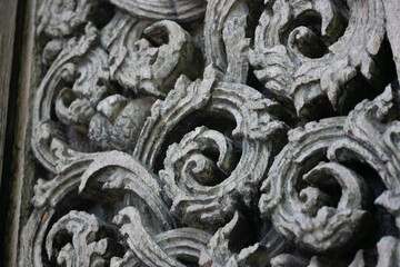 The door of the chapel of Wat Don Sak is made of teak wood, carved with Thai patterns and scrollwork patterns and other Thai architectural pieces, Uttaradit, Thailand