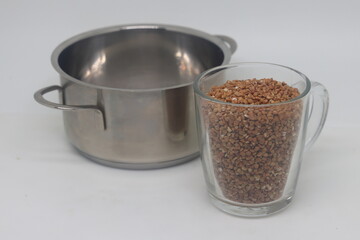 Cooking buckwheat porridge, saucepan and glass with buckwheat, diet food, 2