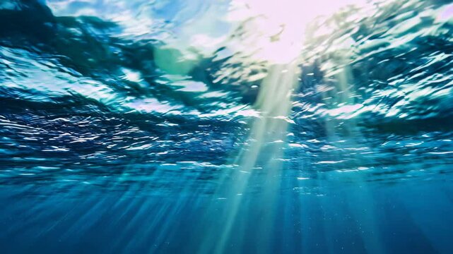 Immerse in the tranquility of an underwater scene showcasing the deep blue ocean and its dynamic waves.