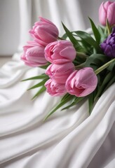 Close-up view of pink and violet tulips elegantly displayed against smooth white silk  , luxurious, nature, macro