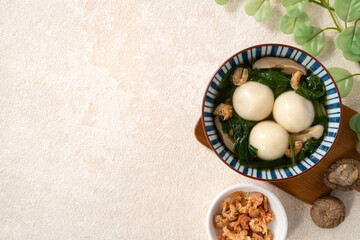 Eating big tangyuan yuanxiao with savory soup in Taiwan.