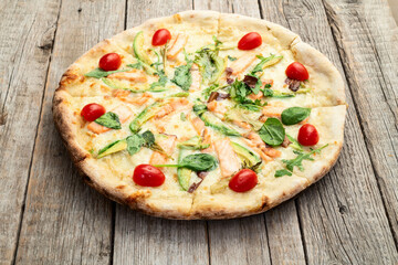 Italian pizza with avocado salmon  tomatoes and mozzarella photography. top view