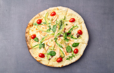 Italian pizza with avocado salmon  tomatoes and mozzarella photography. top view