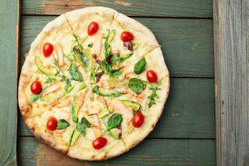 Italian pizza with avocado salmon  tomatoes and mozzarella photography. top view