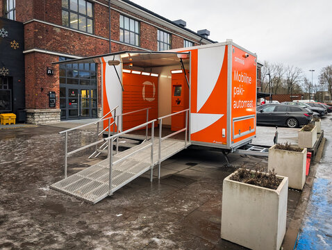 Estonia, Tallinn, December 17, 2024. Mobile parcel terminal of Omniva post office near the Arsenal shopping center.