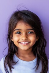 Fototapeta premium Smiling young girl with bright eyes, purple background