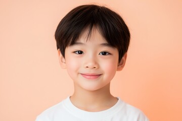 Smiling child with neutral background, youthful innocence.