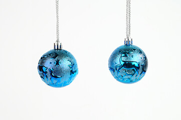 Isolated blue christmas baubles on a white background.