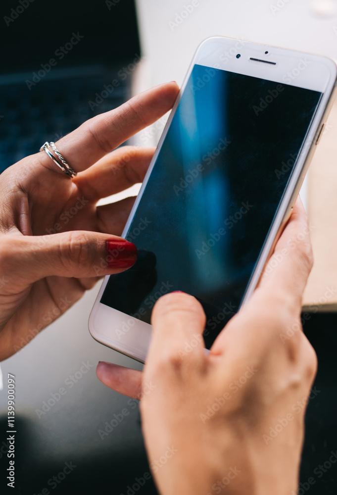 Poster cropped image of female holding mobile phone with empty screen sending and texting messages in chatt