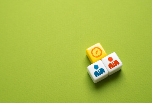 Two business partners are guided by a compass in the direction of their future work. The concept of cooperation and collaboration. Develop a strategy and divide responsibilities.