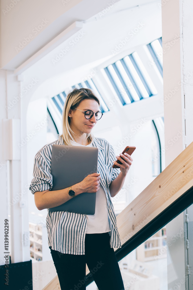 Aufkleber caucasian female blogger holding laptop netbook in hand and connecting to wireless internet on smart