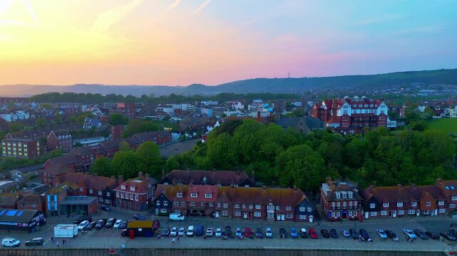Folkestone waterfront, coastal town location, sunset, aerial panning view