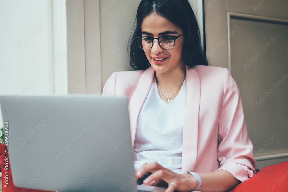 Poster carefree skilled woman watching video and reading news during social networking via modern laptop co
