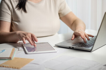 Woman paying bills online using laptop at home. Bill paying concept. Digital payment using internet