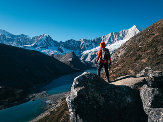 Backpacking woman hiking on high altitude mountain top