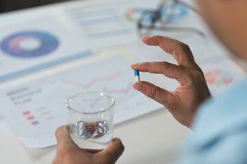 Taking medicine for sick or unwell moments at home health awareness lifestyle indoor close-up...