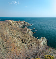 View of the vastness of the Pacific Ocean from the high seashore. High cliffs on the shore of the Pacific Ocean.