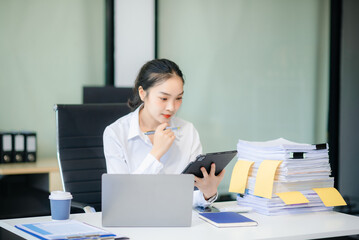  Asian female office worker business suits smiling at camera with working notepad, tablet and laptop documents